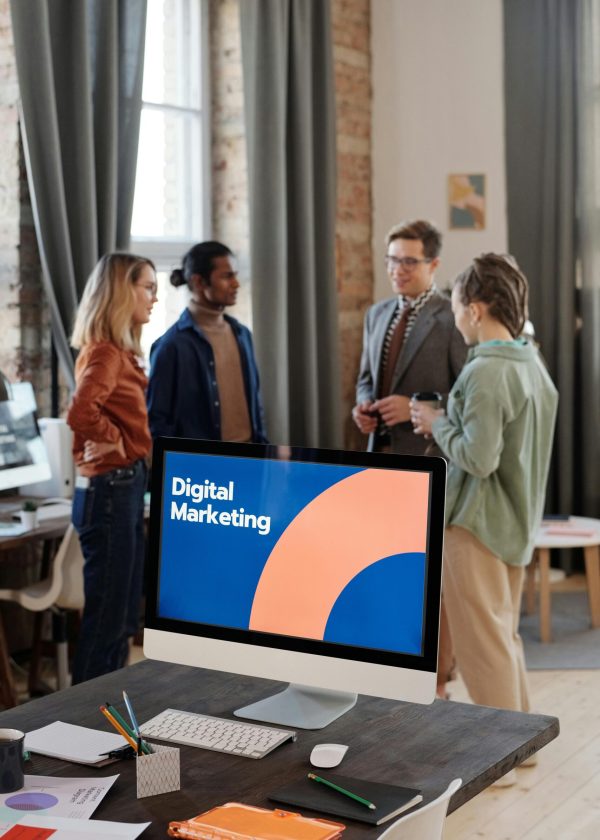 Business team engaged in a digital marketing discussion in a modern office setting.